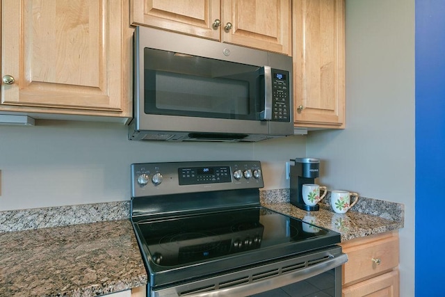 kitchen with light stone countertops, appliances with stainless steel finishes, and light brown cabinets