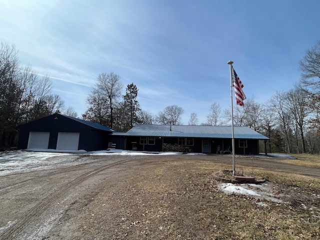 exterior space with metal roof and driveway