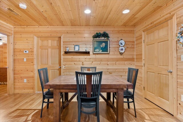 dining area with wooden walls, recessed lighting, wooden ceiling, and light wood-type flooring