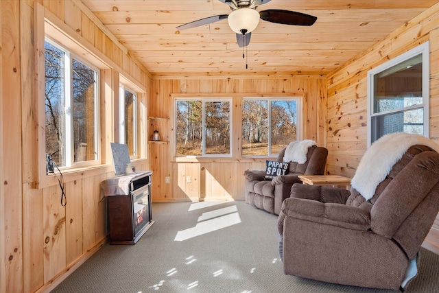 carpeted living room with plenty of natural light, wood walls, and wood ceiling