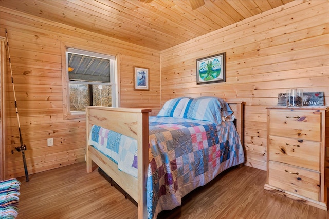 bedroom featuring wooden walls, wood ceiling, and wood finished floors