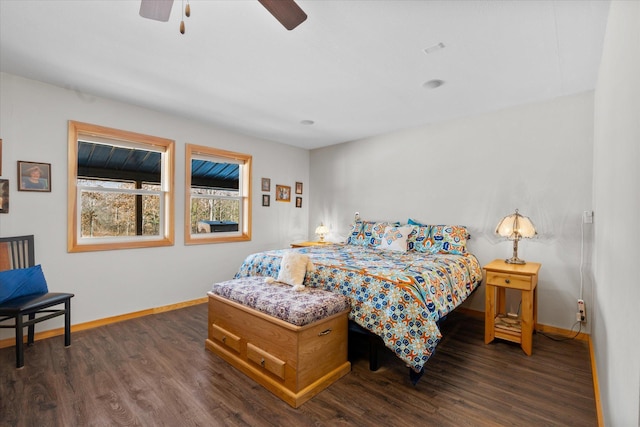 bedroom with baseboards, dark wood-type flooring, and a ceiling fan