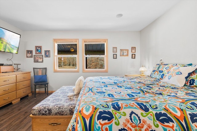 bedroom featuring baseboards and dark wood-style flooring