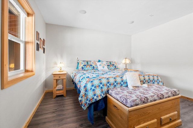 bedroom featuring dark wood-style floors and baseboards