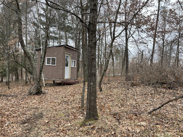 exterior space featuring an outbuilding and stucco siding