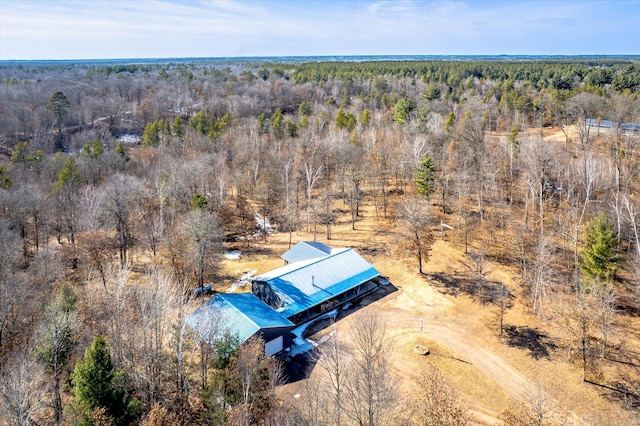 birds eye view of property featuring a view of trees