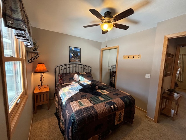 carpeted bedroom featuring a closet, a ceiling fan, and baseboards