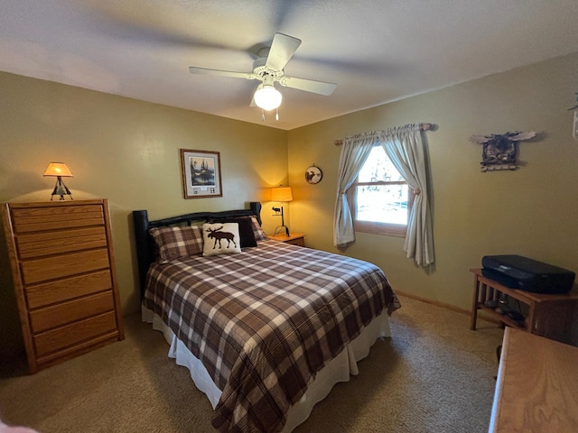 carpeted bedroom with ceiling fan and baseboards