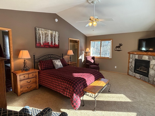 carpeted bedroom with lofted ceiling, ceiling fan, and a fireplace