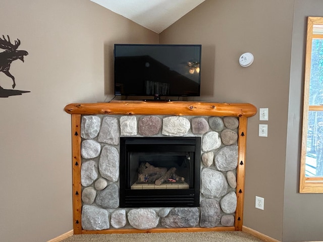 details featuring carpet, a fireplace, and baseboards