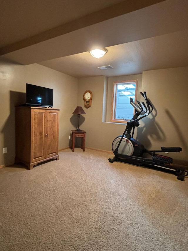 workout area with visible vents and light carpet