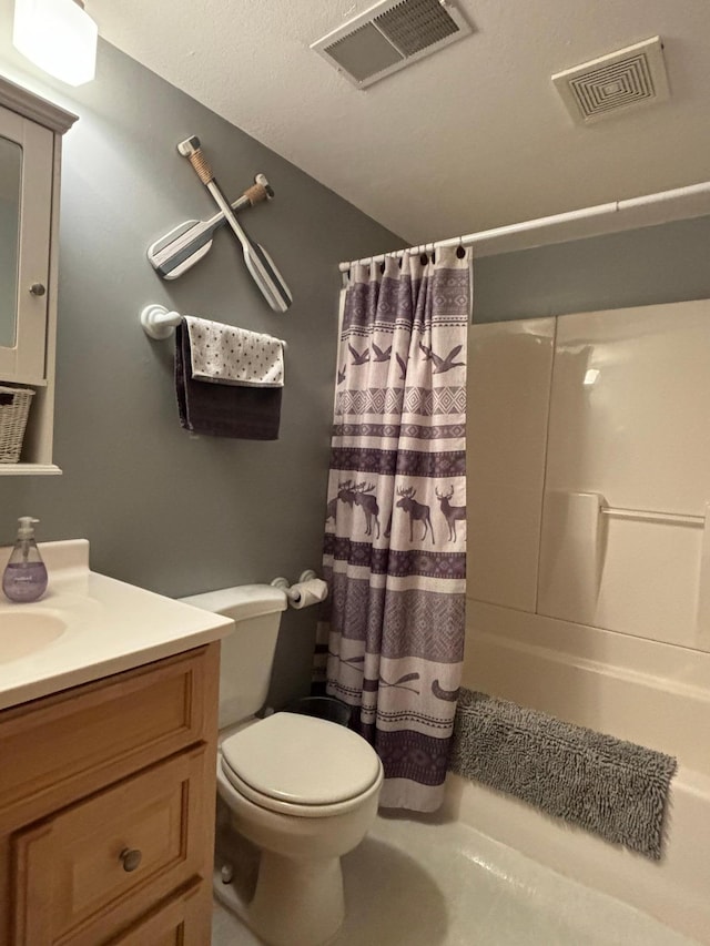 bathroom featuring visible vents, vanity, and toilet