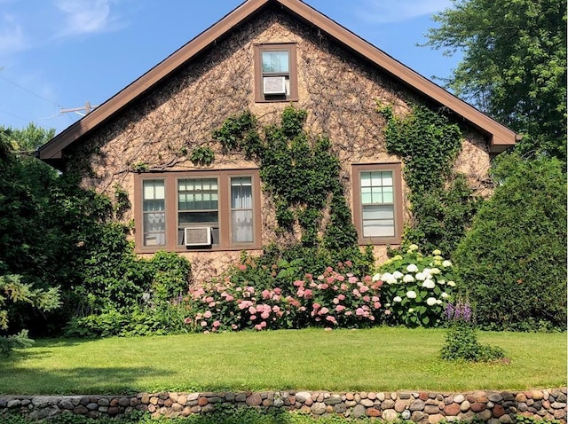 view of home's exterior with a yard and cooling unit