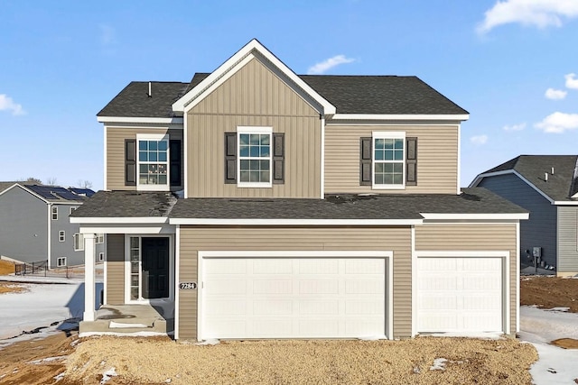 view of front of home with a garage, roof with shingles, and board and batten siding