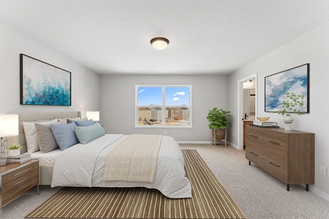 bedroom featuring light colored carpet, baseboards, and a textured ceiling