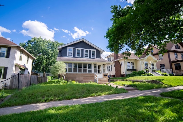 view of front of house featuring a front yard and fence