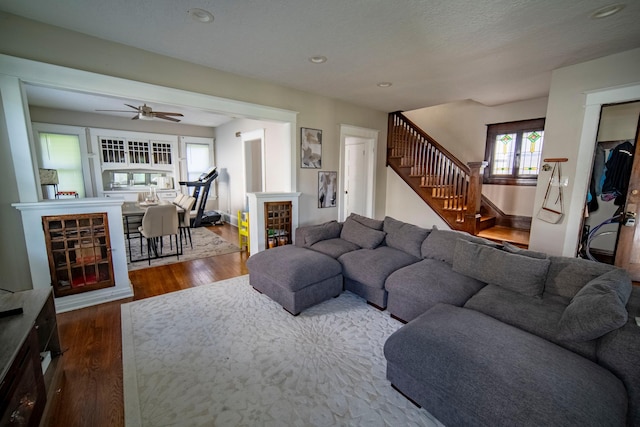 living area featuring stairs, dark wood-type flooring, a ceiling fan, and recessed lighting