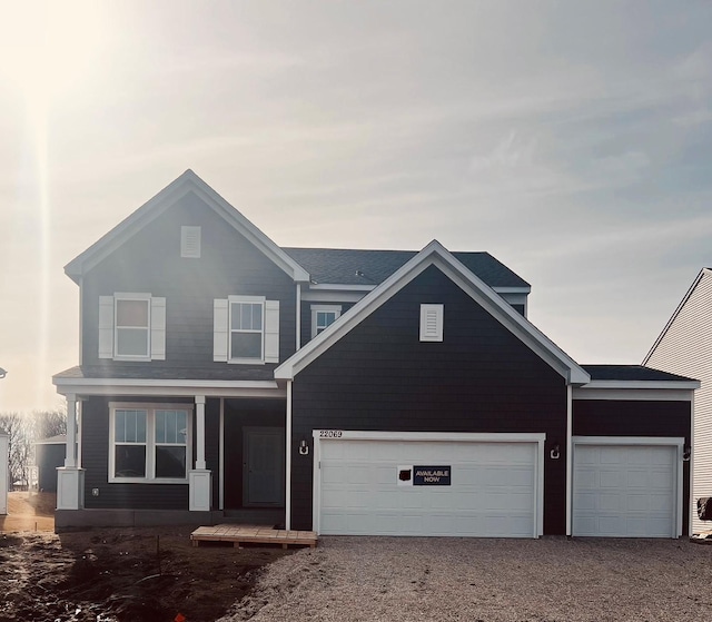 view of front of home featuring a garage and dirt driveway