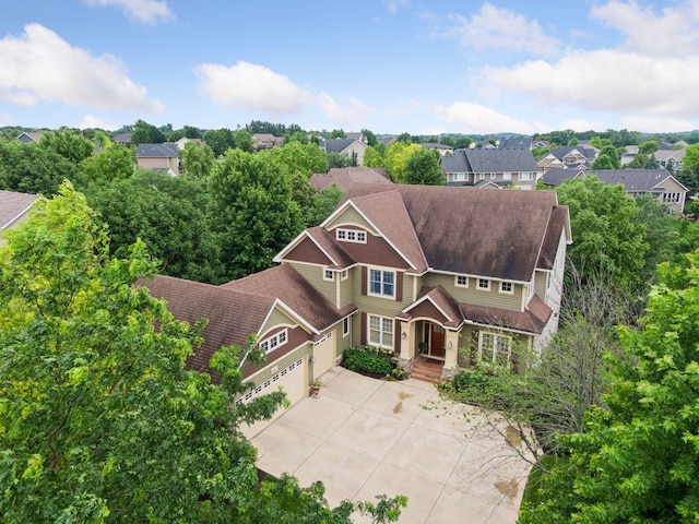 view of front of home featuring a residential view, a garage, and driveway