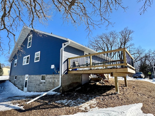 view of snowy exterior with a deck