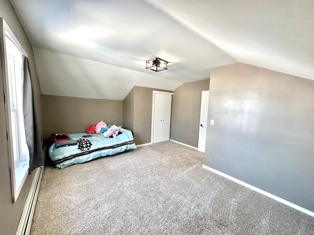 unfurnished bedroom featuring lofted ceiling, a baseboard radiator, carpet floors, baseboards, and a closet