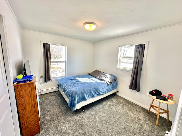 carpeted bedroom featuring multiple windows, baseboards, and baseboard heating