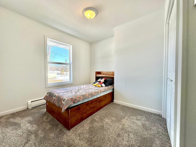 bedroom with a baseboard heating unit, carpet floors, and baseboards