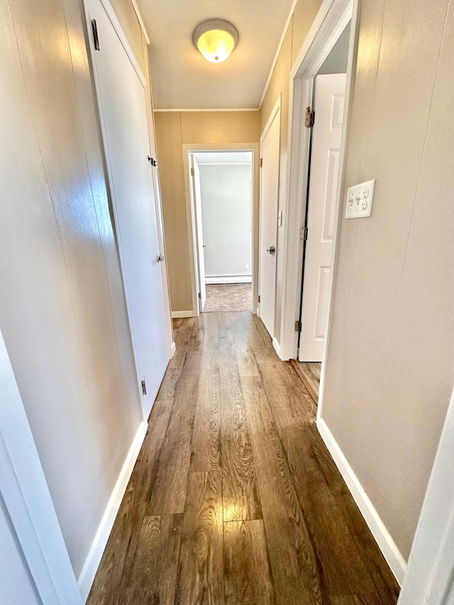 hallway with wood finished floors and baseboards