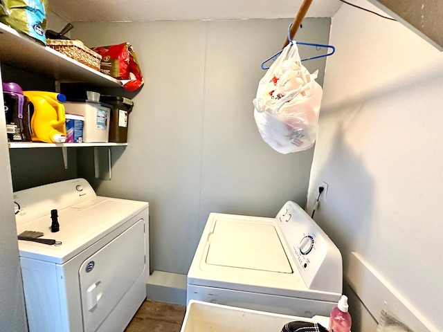 clothes washing area featuring laundry area, wood finished floors, and independent washer and dryer