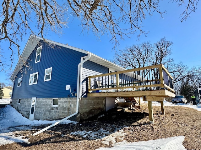 snow covered property featuring a deck