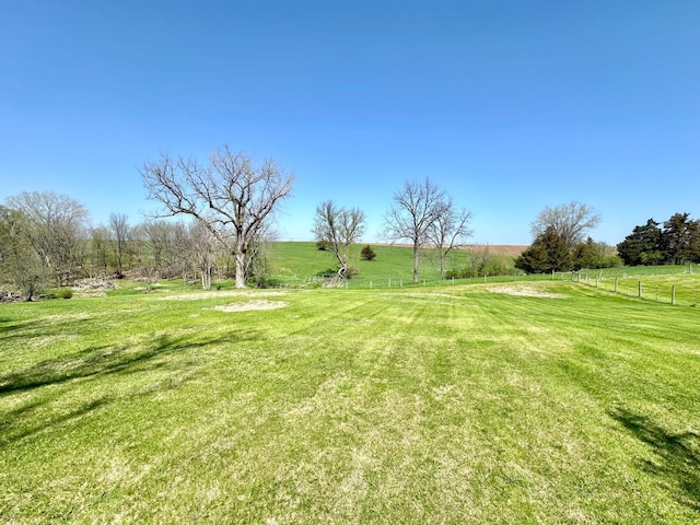 view of yard with a rural view and fence