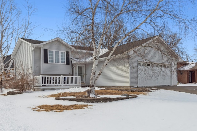 tri-level home featuring a porch and an attached garage