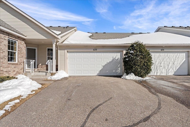 view of front of home with aphalt driveway and a garage