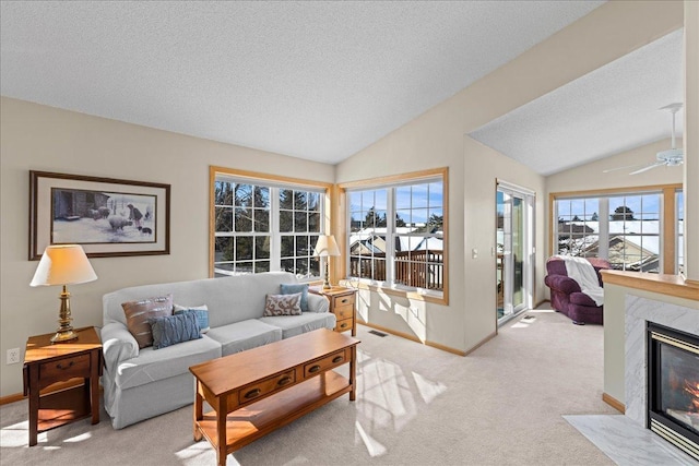 living area featuring a premium fireplace, lofted ceiling, and light carpet