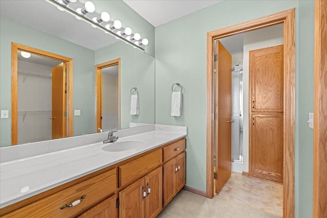 full bath with baseboards and vanity