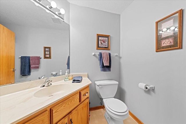 half bath featuring visible vents, baseboards, toilet, vanity, and a textured ceiling