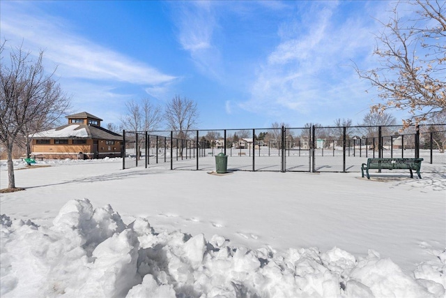 yard covered in snow featuring fence