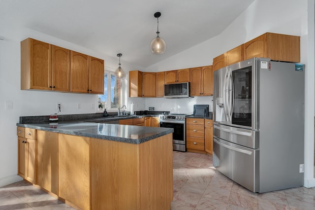 kitchen with a peninsula, stainless steel appliances, marble finish floor, dark countertops, and brown cabinets