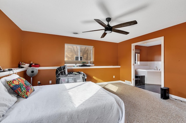 bedroom with visible vents, carpet floors, baseboards, and connected bathroom