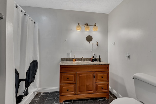 bathroom with tile patterned flooring, toilet, vanity, and baseboards