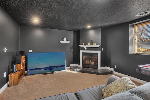 living room with a textured ceiling, a fireplace, baseboards, and carpet