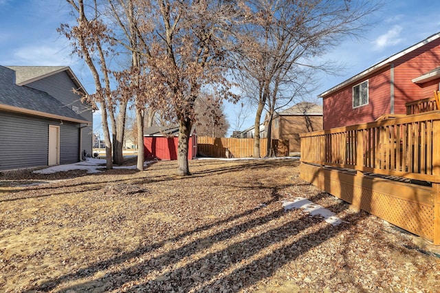 view of yard featuring an outdoor structure and fence