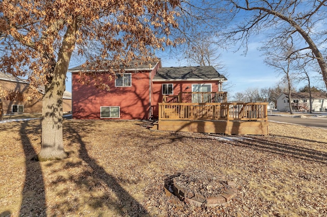 rear view of property featuring a wooden deck