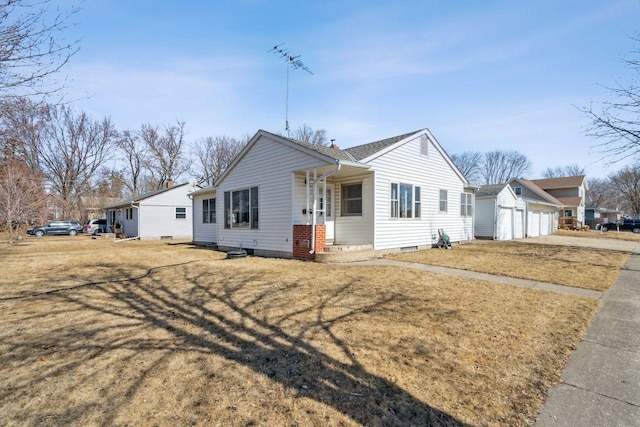 single story home featuring a front yard, an attached garage, and an outdoor structure