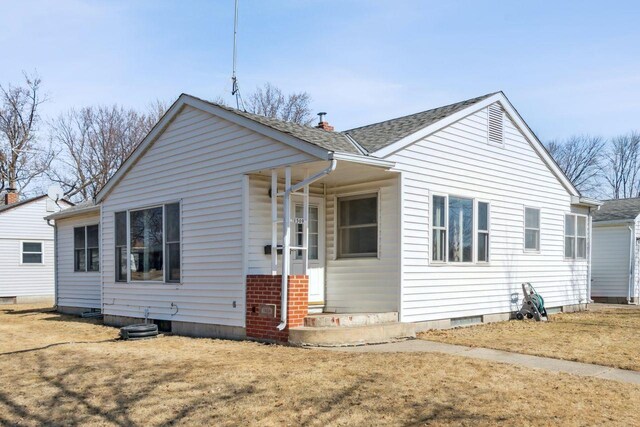 bungalow-style house with crawl space and a shingled roof