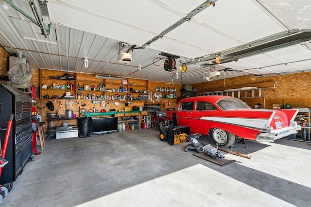 garage with a workshop area and a garage door opener