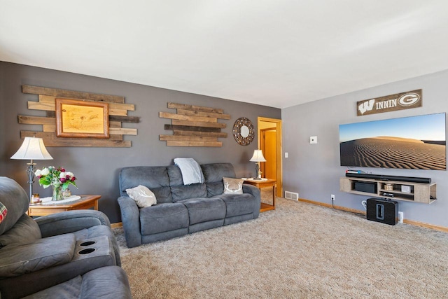 living room featuring baseboards, visible vents, and carpet floors