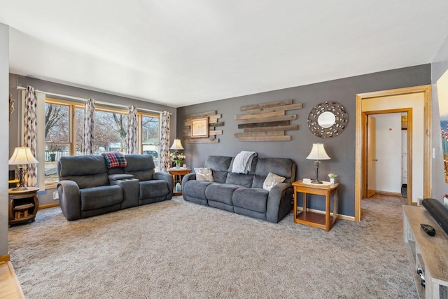 carpeted living area featuring baseboards