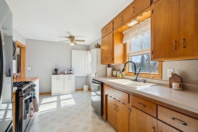 kitchen featuring a sink, stainless steel appliances, light floors, and light countertops