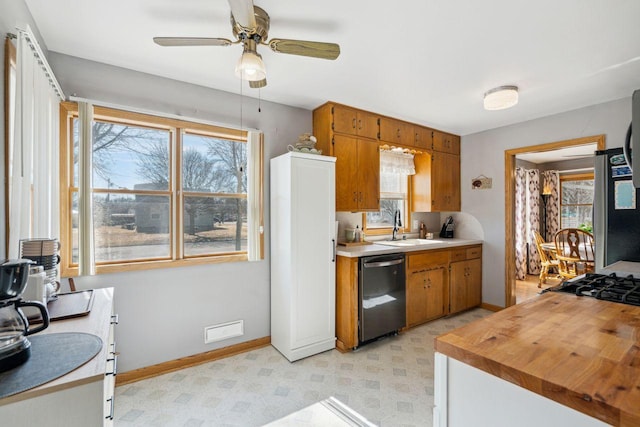 kitchen featuring light floors, visible vents, a sink, light countertops, and appliances with stainless steel finishes